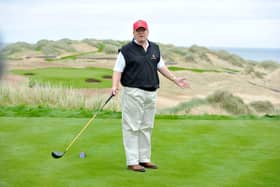 Donald Trump poses for the press on the thirteenth tee of his golf course on the Menie Estate, Balmedie, Aberdeenshire