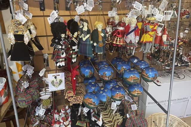 Customers at Ye Olde Christmas Shoppe have been snapping up all sorts of Scottish-themed baubles and trinkets -- including novelty waving Queen decorations, which are now sold out. Picture: Ilona Amos
