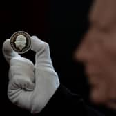 The official coin effigy of King Charles III with a new £5 Crown commemorating the life and legacy of Queen Elizabeth II (Picture: Aaron Chown/PA)