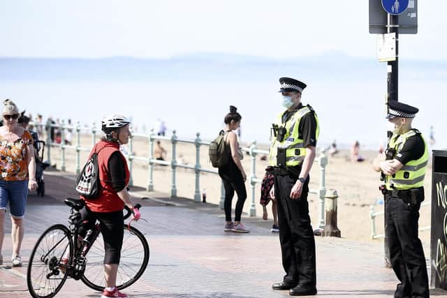 Police in masks patrol Portobello Beach yesterday afternoon and stop to speak to people on the the beach and promenade