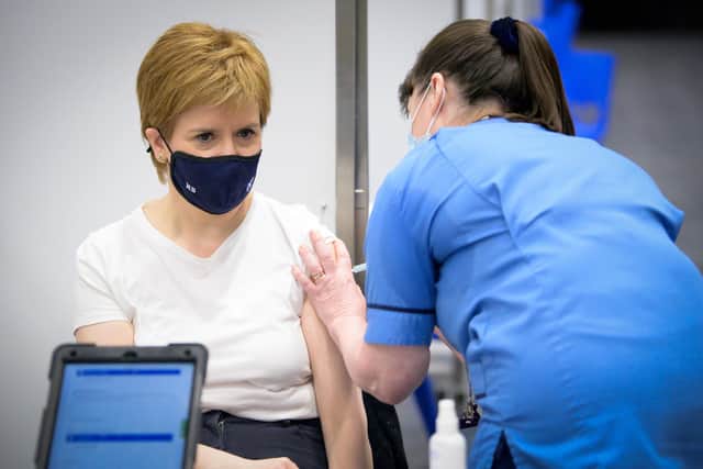 First Minister of Scotland Nicola Sturgeon receives the first shot of the Astra Zeneca vaccine, administered by staff nurse Elaine Anderson, at the NHS Louisa Jordan vaccine centre in the SSE Hydro in Glasgow, Scotland. Picture date: Thursday April 15, 2021.