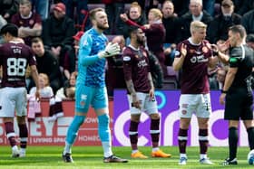 Hearts players remonstrate with referee Alex Cochrane after the defender is harshly sent off. Picture: SNS