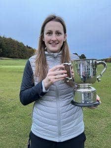 Broomieknowe's Kate McIntosh shows off the trophy after winning the East Women's Championship at Turnhouse. Picture: MCLGA
