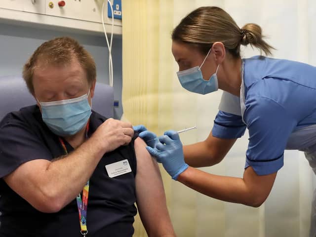 Deputy charge nurse Katie McIntosh giving Clinical Lead of Outpatient Theatres Andrew Mencnarowski, a Covid vaccine at the Western General Hospital in Edinburgh, on December 8.