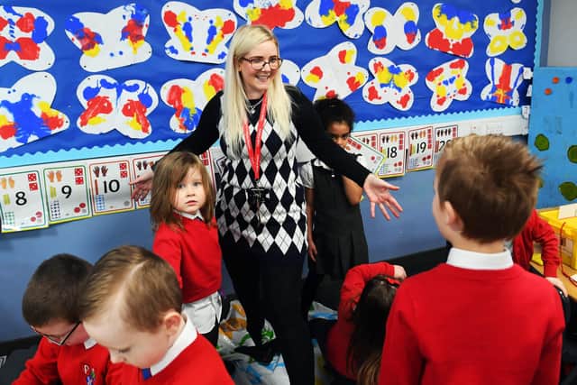 A teacher leads pupils in an activity during class at Clyde Primary School in Glasgow on February 22, 2021 as schools in Scotland started to reopen to more of the youngest students in an easing of the coronavirus shutdown. (Photo by Andy Buchanan / AFP) (Photo by ANDY BUCHANAN/AFP via Getty Images)
