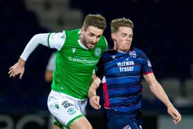 Jason Naismith vies for the ball with Ross County's Josh Mullin during the full-back's spell at Easter Road