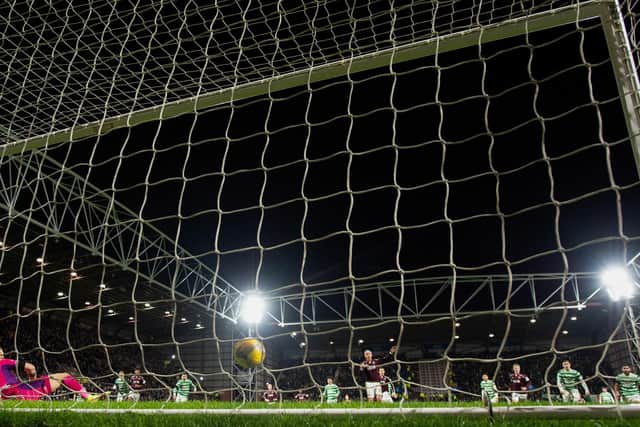 Tynecastle Park watches on as the ball travels agonisingly across the face of goal after striking Joe Hart's right-hand post. Picture: SNS