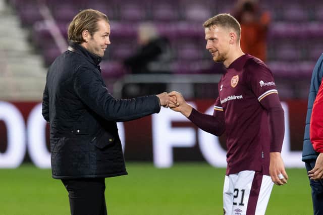 Robbie Neilson congratulates two-goal hero Stephen Kingsley after Hearts defeated Dundee.