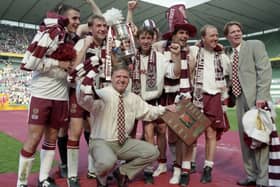 Managing Jim Jefferies, front-centre, with his victorious Hearts players after the 1998 Scottish Cup final. Picture: SNS