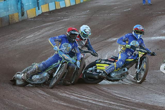 Monarchs duo Kye Thomson (red) and Paco Castagna (blue) get the better of Redcar's guest rider Richard Lawson. Picture: Jack Cupido.