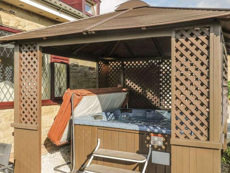 The property boasts an outdoor, covered hot tub.