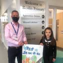BEAR Scotland’s South East Planned Maintenance Manager Jamie Finlayson meeting 11-year-old Indira Williams from Roslin Primary School, who designed the winning poster “What a sin not to bin”