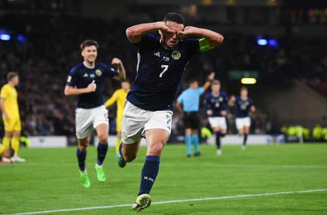 Scotland midfielder John McGinn, formerly of Hibs, celebrates in typical style after netting the opener in a 3-0 victory over Ukraine. Picture: SNS