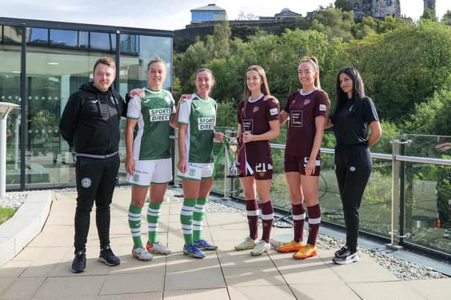 Hibs boss Dean Gibson with players Eilidh Adams and Shannon Leishman, alongside Hearts trio Gwen Davies, Georgia Hunter and manager Eva Olid. Leishman and Davies are holding the Capital Cup. Picture: Contributed