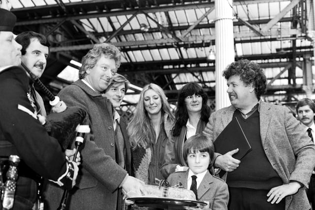The people behind the film 'Chariots of Fire' are welcomed at Waverley Station in Edinburgh by a piper and a boy with a haggis in April 1981.
