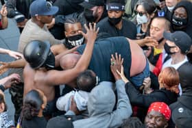A group of Black Lives Matter demonstrators saved a white man who was taking part in a far-right counter-protest after he got into trouble (Picture: SWNS)