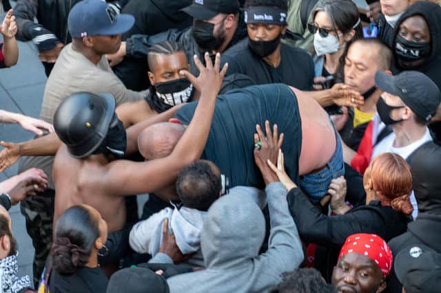 A group of Black Lives Matter demonstrators saved a white man who was taking part in a far-right counter-protest after he got into trouble (Picture: SWNS)