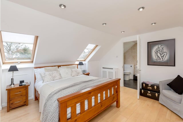 The master bedroom has wall-to-wall fitted storage and a contemporary en-suite shower room.