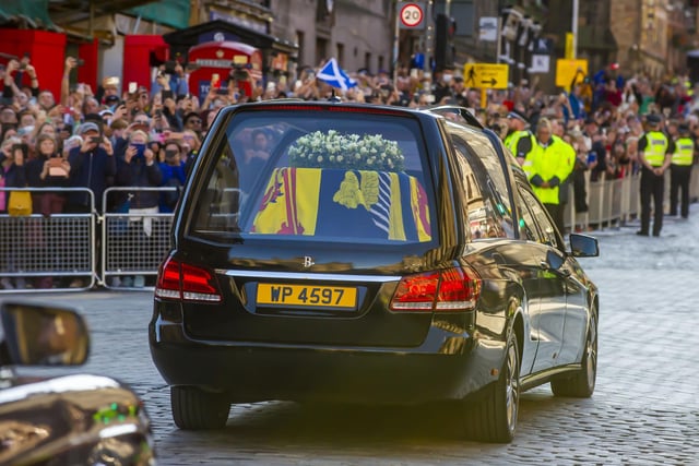 The hearse carrying the coffin of Queen Elizabeth II departs St Giles' Cathedral, for Edinburgh Airport, where it was flown by the Royal Air Force to RAF Northolt. Photo: Lisa Ferguson/The Scotsman