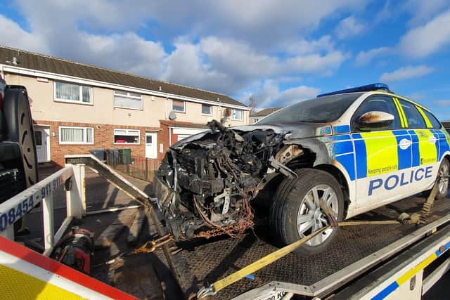 A burnt-out police car was removed from Cleekim Drive this morning, after an incident last night in which a group of men threw fireworks at a vehicle.