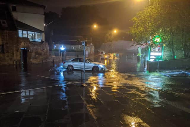 Images show cars abandoned in Canonmills as police shut Huntly Street due to flooding.