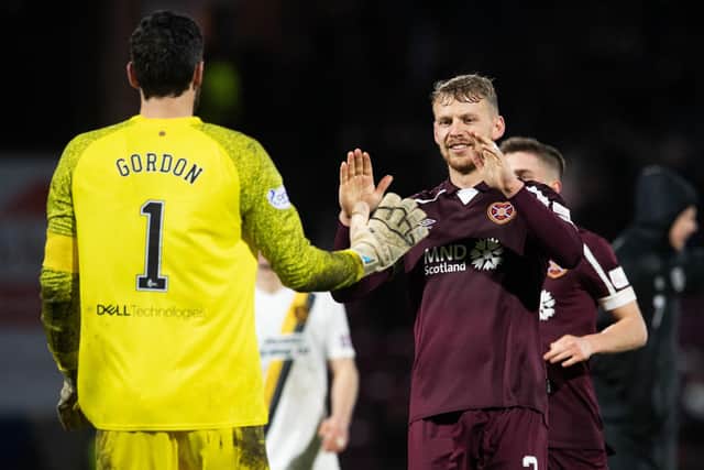 Craig Gordon is congratulated by Stephen Kingsley after Hearts defeat Livingston on penalties. Picture: SNS