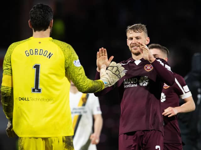 Craig Gordon is congratulated by Stephen Kingsley after Hearts defeat Livingston on penalties. Picture: SNS