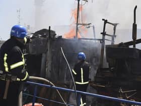 Firefighters put out a fire in a port after a Russian missiles attack in Odesa, Ukraine, on Saturday. Picture: Odesa City Hall Press Office via AP