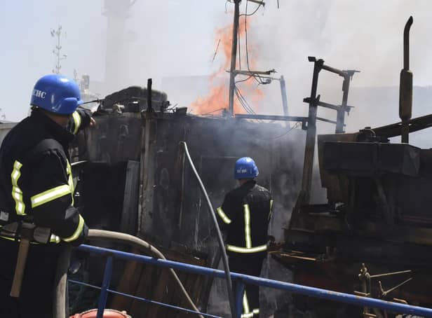 Firefighters put out a fire in a port after a Russian missiles attack in Odesa, Ukraine, on Saturday. Picture: Odesa City Hall Press Office via AP