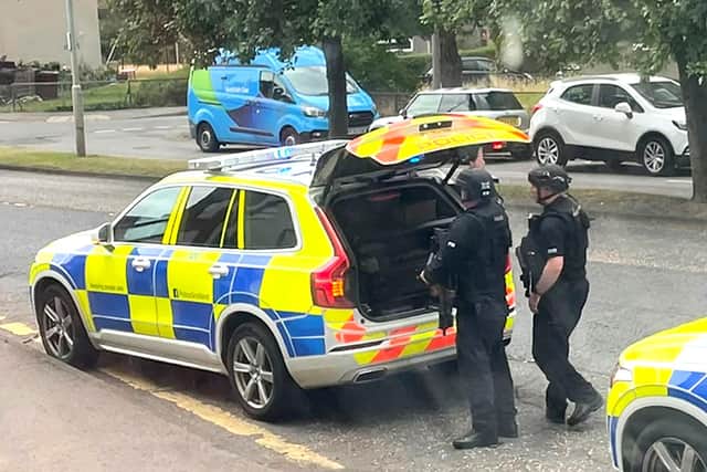 Armed police in Ferry Road Drive in Edinburgh, after a hit-and-run crash which left a 24-year-old man seriously injured, in nearby Ferry Road Drive.