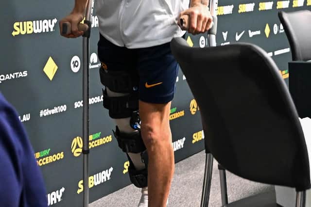 Australia's Martin Boyle leaves on crutches after the press conference. Picture: CHANDAN KHANNA/AFP