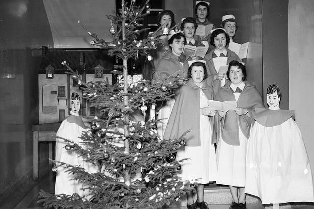 Royal Infirmary  of Edinburgh nurses sing carols round the Christmas tree on Christmas Day in 1958.