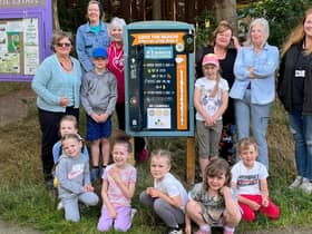 Children and staff from Kidz Stop next to one of the newly installed litter picking boards.
