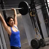 A woman lifts weight during crossfit training in a gym in Paris (Photo: BERTRAND GUAY/AFP via Getty Images)
