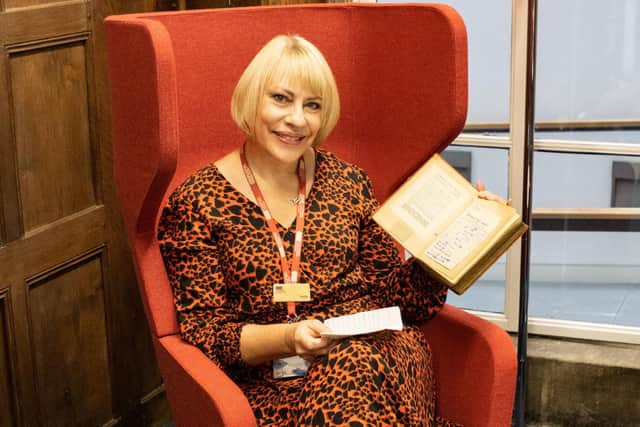 Cultural services assistant Donna Dewar with the library book that has been returned more than 73 years late.