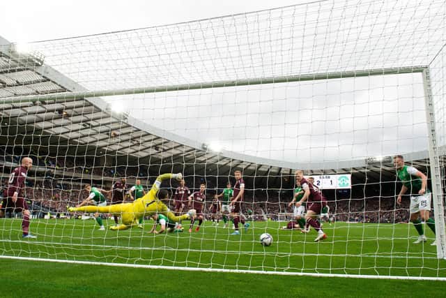Hearts goalkeeper Craig Gordon turns a Ryan Porteous header on to the post in a big moment