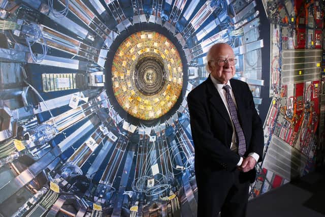 Professor Peter Higgs stands in front of a photograph of the Large Hadron Collider at the  Science Museum's 'Collider' in London in 2013.  Photo: Peter Macdiarmid/Getty Images