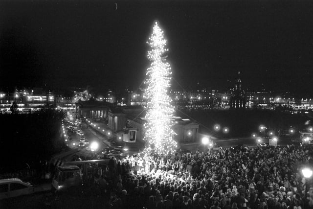 Crowds gather at The Mound in Edinburgh to watch the lights of the Norwegian Christmas tree being switched on, December 1988. The tree is an annual gift from the people of Norway in thanks for the UK's assistance during World War II.