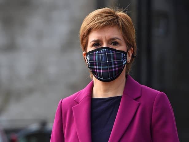 Nicola Sturgeon wearing a protective face covering while campaigning with Edinburgh Western candidate Sarah Masson on April 20 in South Queensferry, Scotland (Photo by Andy Buchanan - Pool/Getty Images).