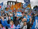 Pro-independence campaigners at a rally ahead of the 2014 referendum. A new study says continuing support for independence will keep the SNP afloat despite its current troubles (Picture: Jeff J Mitchell/Getty Images)