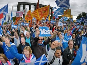Pro-independence campaigners at a rally ahead of the 2014 referendum. A new study says continuing support for independence will keep the SNP afloat despite its current troubles (Picture: Jeff J Mitchell/Getty Images)