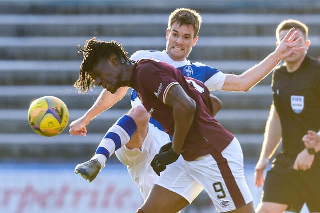 Hearts' Armand Gnanduillet and Morton's Kyle Jacobs tussle at Cappielow.