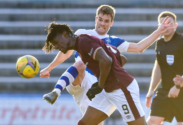 Hearts' Armand Gnanduillet and Morton's Kyle Jacobs tussle at Cappielow.
