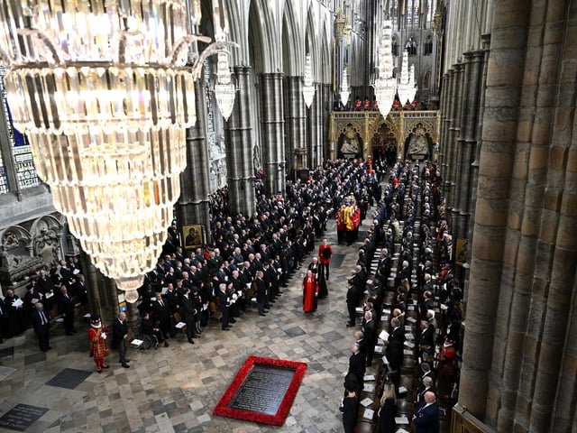The coffin of Queen Elizabeth II with the Imperial State Crown resting on top of it departs Westminster Abbey during the State Funeral. (Photo by Gareth Cattermole/Getty Images)