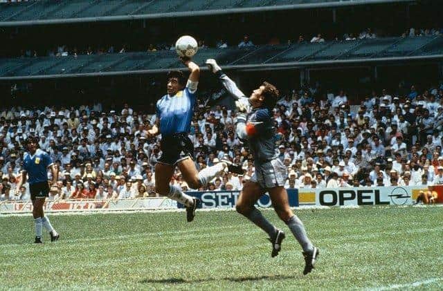 Diego Maradona's first goal against England is an iconic moment in football history. (Picture credit: Getty Images)