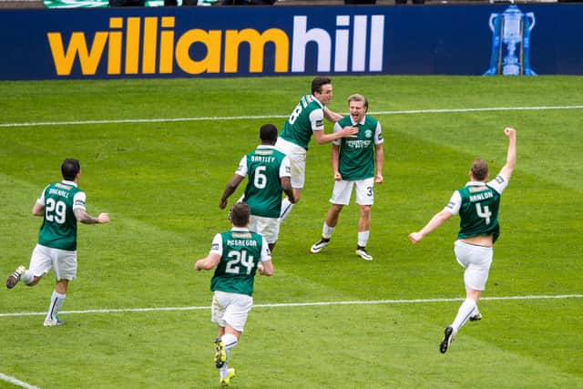 Hibs players swarm around Jason Cummings after his winning penalty in the 2016 semi-final.