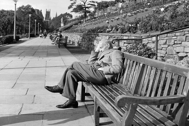 An unidentified elderly man takes a wee break on a park bench in Princes Street Gardens in 1964.
