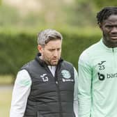Hibs manager Lee Johnson walks out to training with striker Élie Youan, who could be involved from the start on Saturday