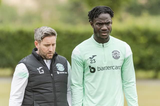 Hibs manager Lee Johnson walks out to training with striker Élie Youan, who could be involved from the start on Saturday