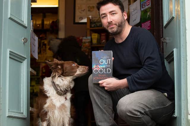 Former police officer, crime writer and dog shop owner Stuart Johnstone with Holly the dog